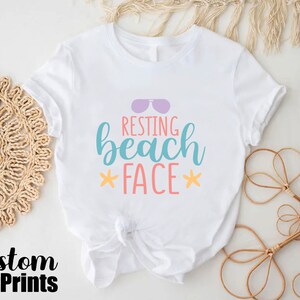 a white shirt with the words resting beach face on it