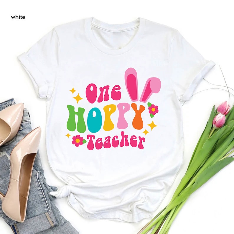 a t - shirt with the words one hoppy teacher on it