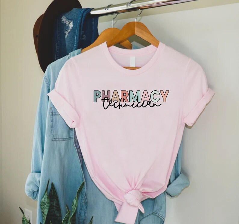 May include: Pink t-shirt with the text "Pharmacy Technician" in colorful letters.