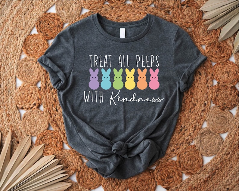 May include: A dark grey t-shirt with the text "Treat all peeps with kindness" and a row of colourful marshmallow peeps.