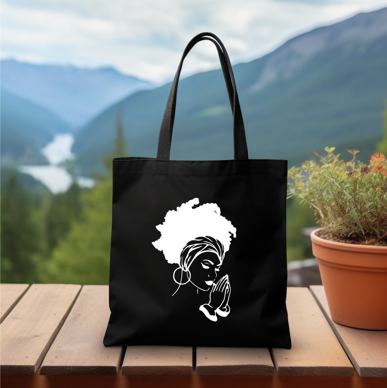 a black tote bag with a picture of a woman's head
