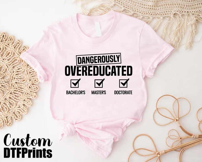 a pink shirt that says dangerous is overeducated
