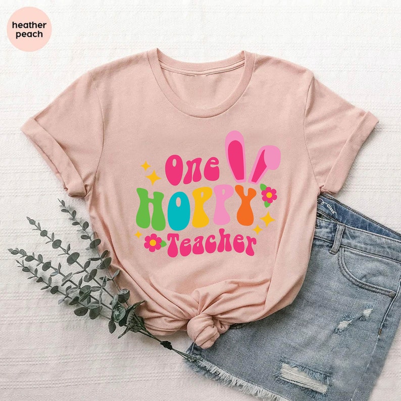 a t - shirt with the words one happy teacher on it