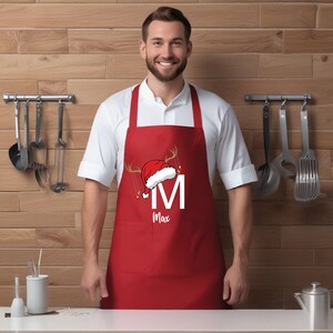 a man wearing an apron and a santa hat