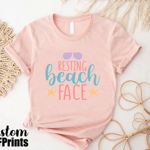 a pink shirt that says resting beach face