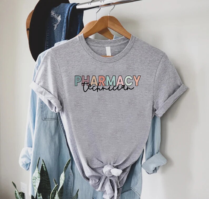 May include: Gray t-shirt with the text "PHARMACY Technician" in colorful letters.