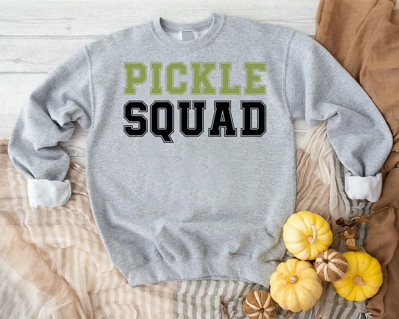 May include: A gray sweatshirt with the text "PICKLE SQUAD" in black and green letters.