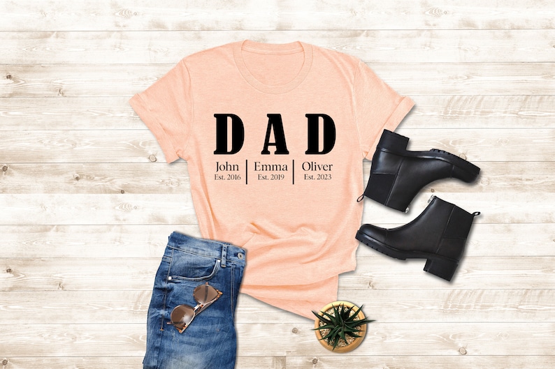a t - shirt that says dad and a pair of jeans