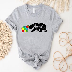 a t - shirt with a bear and puzzle pieces on it
