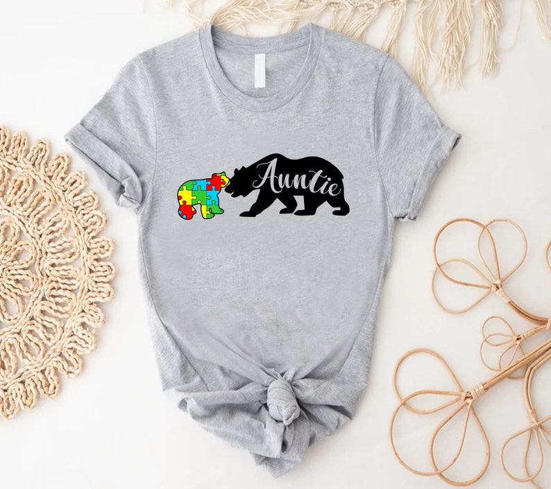 a t - shirt with a bear and puzzle pieces on it