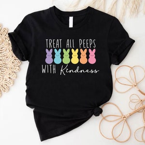 May include: Black t-shirt with a rainbow row of cartoon peeps and the text "Treat all peeps with kindness".