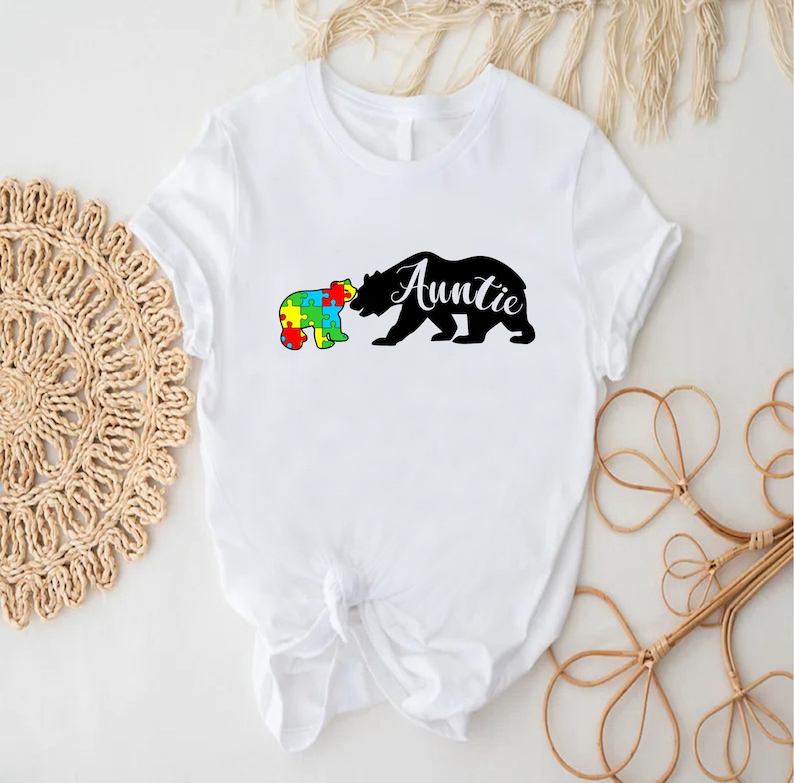 a t - shirt with a bear and a puzzle piece on it