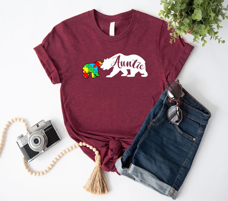 a t - shirt that says autism with a bear on it