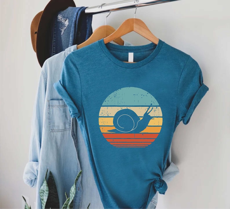 a blue shirt with a snail on it