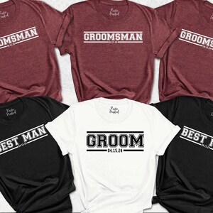May include: Five t-shirts with different text designs. The shirts are in black, white, and maroon. The text on the shirts includes "Groom", "Best Man", and "Groomsman" with the date "04.15.24".