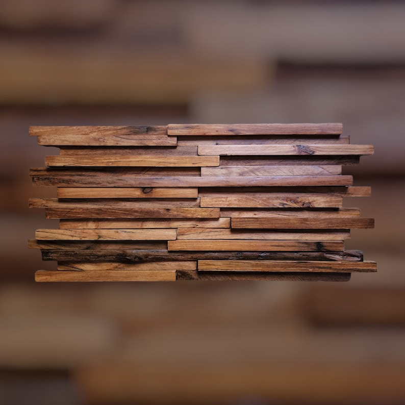 May include: A wall panel made of reclaimed wood planks, arranged in a staggered pattern. The wood is a mix of light and dark brown tones, with a rustic and weathered look.