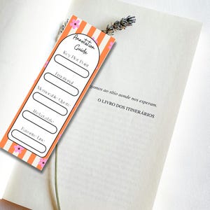 May include: A rectangular bookmark featuring orange and white vertical stripes with small pink flower accents. The text reads Annotation Guide, Key Plot Point, Emotional, Memorable Quote, Relatable, and Favorite Line with blank spaces for notes.