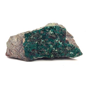 May include: A rough-hewn rock formation with a vibrant green mineral deposit. The stone has a mottled, gray-brown exterior, contrasting with the rich, emerald-colored interior. The mineral appears crystalline and textured, creating a striking visual display.