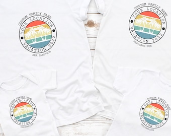 May include: A set of three white t-shirts with a retro-style design featuring palm trees and the text "CUSTOM FAMILY NAME YOUR LOCATION VACATION 2022 SEA | SAND | SUN".