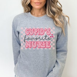 Cupids Favorite Nurse Sweatshirt Retro Nurse Valentines Day Crewneck Sweater ER Nurse Cute VDay Womens Funny RN Valentines Day Sweatershirt