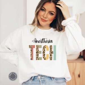 May include: White sweatshirt with the text "Anesthesia TECH" in colorful letters with a leopard print pattern.