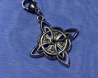 May include: Silver Celtic knot charm with a lobster clasp. The knot is a traditional design with four interlocked loops.