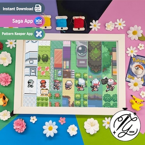 May include: A framed cross-stitch depicting a pixelated video game scene with characters. The artwork is surrounded by colourful thread spools, artificial flowers, and a Pokémon card. The frame is white.