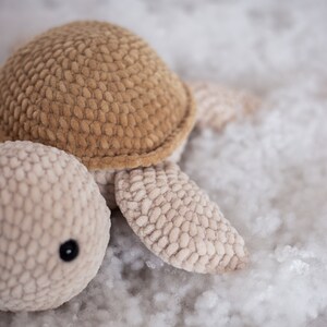 A close-up view of the turtle. Since this is a handmade crochet toy, the photos showcase its texture up close, revealing the intricate craftsmanship.