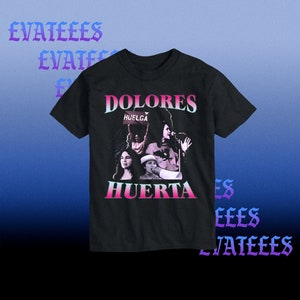 May include: Black t-shirt with a graphic print of Dolores Huerta, a Latina activist, with the text "Dolores Huerta" and "Huelga" in pink and blue lettering.