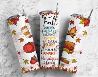 May include: A white tumbler with a fall-themed design. The tumbler features a variety of fall-themed illustrations, including pumpkins, leaves, bonfires, and a cup of hot cocoa. The text on the tumbler reads "Fall, Bonfires, Smores, Candy Corn, Sweaters, Hot Cocoa, Hay Rides, Flannel, Pumpkins, Pumpkin Pie & Family".