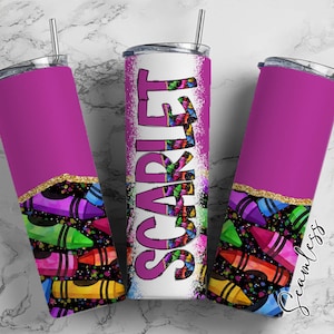 May include: A pink stainless steel tumbler with a white stripe and the name "SCARLET" in black lettering. The tumbler is decorated with a colorful crayon pattern.