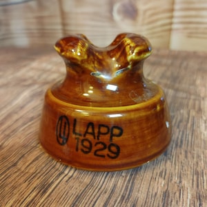 May include: A brown ceramic insulator with the text "LAPP 1929" on the bottom.