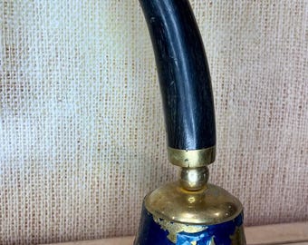 Mexican brass table bell featuring a celestial sun face design.