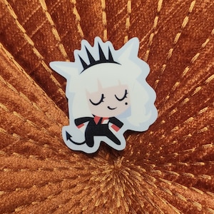 May include: A white and black cartoon sticker of a character with a crown, wearing a black dress and white gloves. The character has closed eyes and a smiling expression.