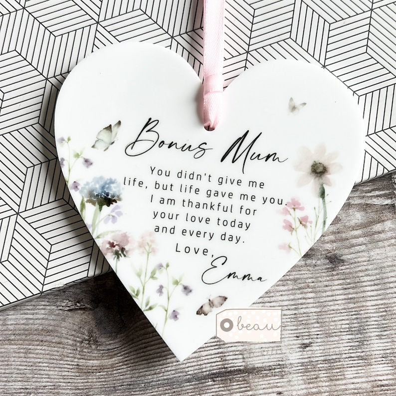 May include: White ceramic heart-shaped ornament with a floral design and the text "Bonus Mum You didn't give me life, but life gave me you. I am thankful for your love today and every day. Love, Emma"
