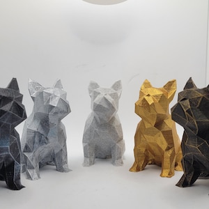 May include: Five geometric French bulldog figurines in different colours: black, silver, white, gold, and bronze.