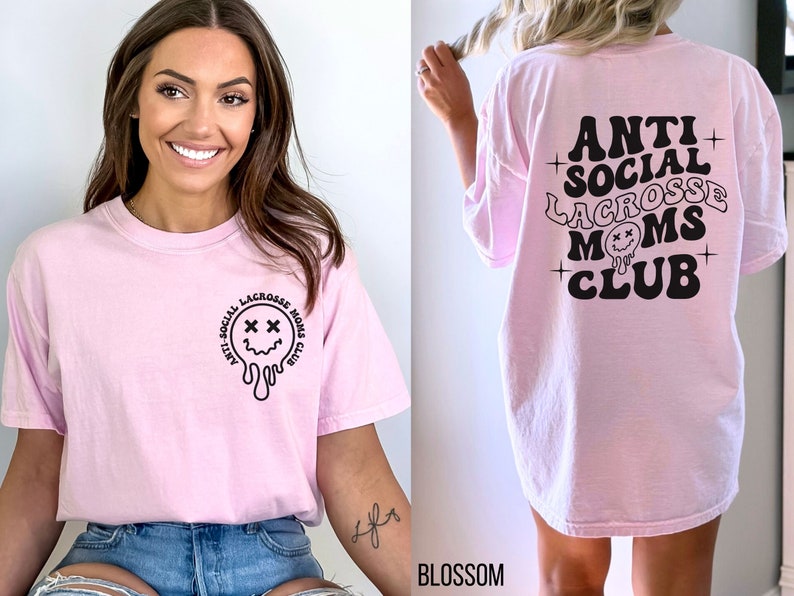 May include: Pink t-shirt with a black graphic that says "Anti-Social Lacrosse Moms Club" and a dripping smiley face with X's for eyes. The back of the shirt has the same graphic but without the smiley face.