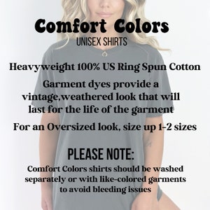 May include: A grey unisex t-shirt made from heavyweight 100% US ring spun cotton. The shirt features the text "Comfort Colors" and "Unisex Shirts" in black. The text "Heavyweight 100% US Ring Spun Cotton" is also in black. The text "Garment dyes provide a vintage, weathered look that will last for the life of the garment" is in black. The text "For an Oversized look, size up 1-2 sizes" is in black. The text "PLEASE NOTE: Comfort Colors shirts should be washed separately or with like-coloured garments to avoid bleeding issues" is in black.