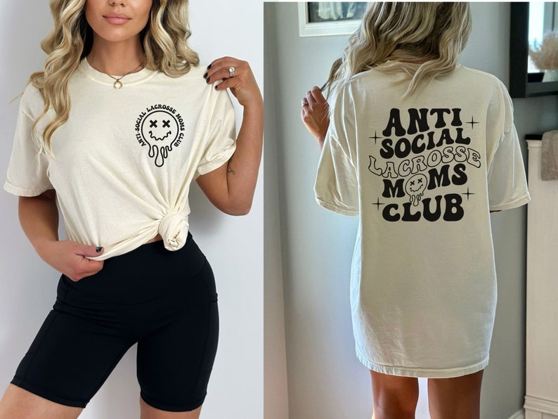 May include: A white t-shirt with a black graphic that says "Anti Social Lacrosse Moms Club" and a dripping smiley face with X's for eyes.