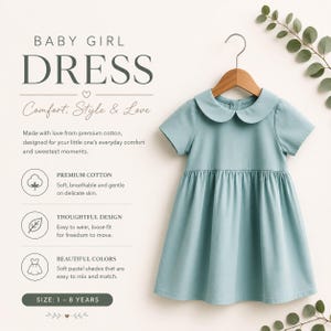 May include: A solid light blue dress with short sleeves and a rounded Peter Pan collar, hanging on a wooden hanger. The text on the image reads: BABY GIRL DRESS, Comfort, Style & Love, Made with love from premium cotton, PREMIUM COTTON, THOUGHTFUL DESIGN, BEAUTIFUL COLORS, SIZE: 1 - 8 YEARS.