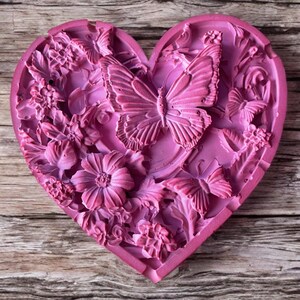 May include: A set of three ceramic mugs with a speckled, matte finish. The mugs are in shades of cream, light gray, and dark gray. Each mug has a simple, minimalist design and a rounded handle.