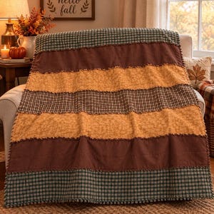 May include: A rectangular rag quilt featuring horizontal stripes of fabric in alternating patterns and solid colors. The design includes dark green and white gingham, solid dark brown, and mustard yellow with a subtle floral print.