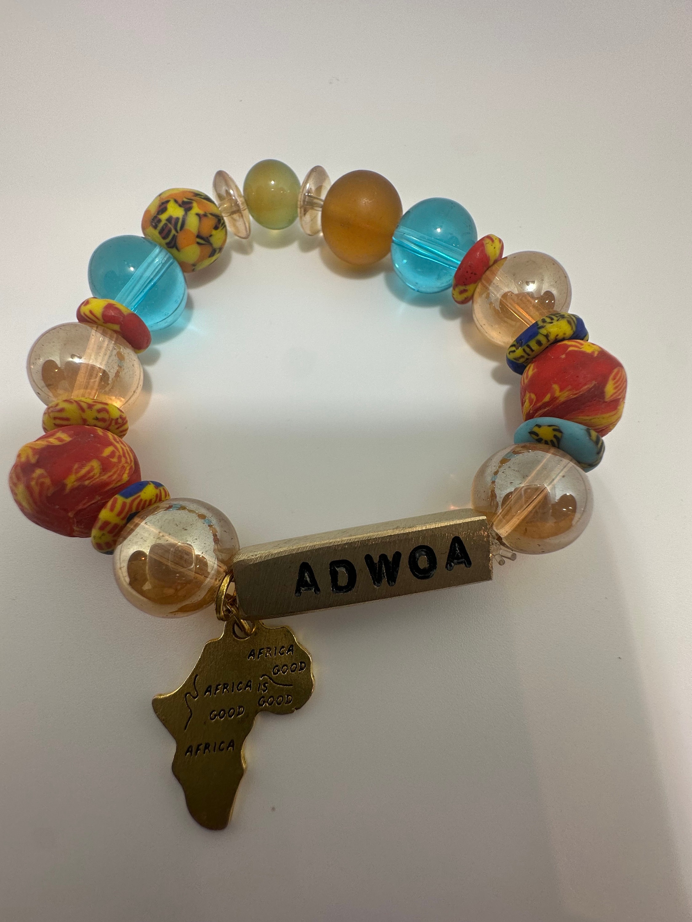 A Ghana Africa Beads Bracelets, symbolizing the beauty and tranquility that can be disrupted by a lake Elsinore storm, with a backdrop of a flooded area, highlighting the importance of navigating through debris safely