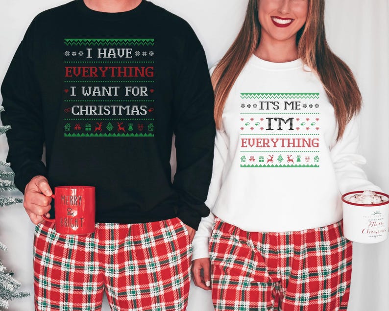May include: Matching black and white Christmas sweaters with festive text. The black sweater reads "I HAVE EVERYTHING I WANT FOR CHRISTMAS." The white sweater says "IT'S ME, I'M EVERYTHING." Both are paired with red plaid pajama pants.