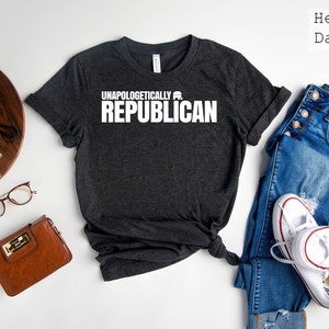 May include: Heather dark grey t-shirt with the text "Unapologetically Republican" in white.