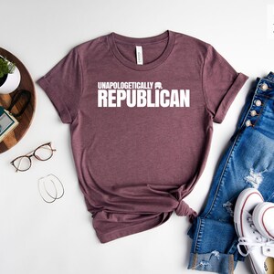 May include: Heather maroon t-shirt with the text "Unapologetically a Republican" printed in white.