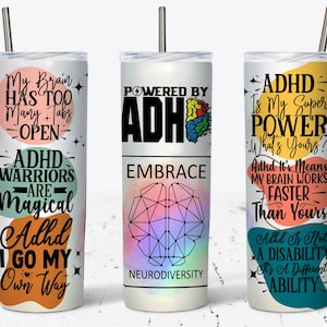 May include: Three white stainless steel tumblers with colorful ADHD-themed quotes and graphics. The tumblers feature phrases like "My Brain Has Too Many Tabs Open" and "ADHD Is My Super Power." Each tumbler has a silver straw.