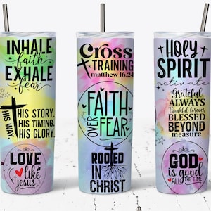 May include: Three stainless steel tumblers with colorful watercolor backgrounds and inspirational Christian quotes. The first tumbler says "Inhale faith, exhale fear" and "His way, His story, His timing, His glory." The second tumbler says "Cross Training Matthew 16:24" and "Faith over Fear." The third tumbler says "Holy Spirit activate" and "Grateful Always Thankful Forever Blessed Beyond Measure."