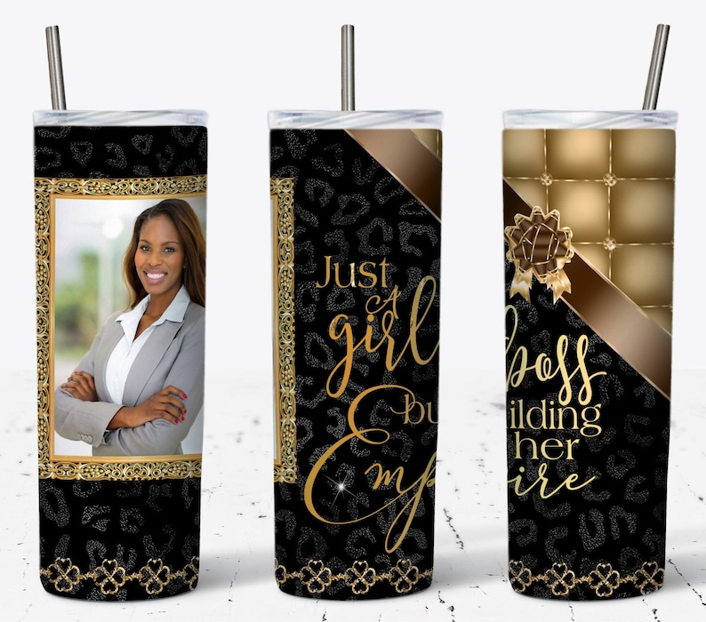 May include: A black and gold tumbler with a leopard print design and the text "Just a girl building her empire". The tumbler has a straw and a photo of a woman in a suit jacket.