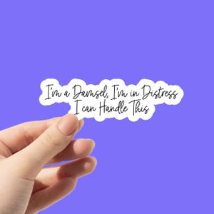 May include: White sticker with black text that reads "I'm a Damsel, I'm in Distress I can Handle This".